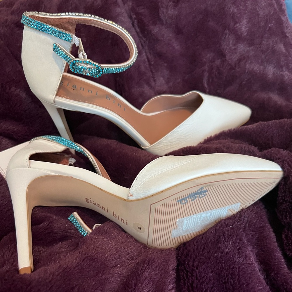White pumps with turquoise rhinestone strap.